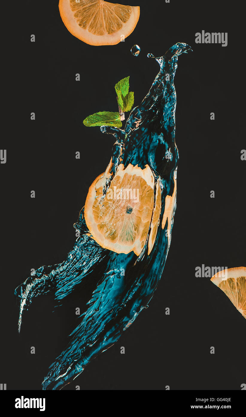 Lemon slice with a splash of water and mint leaf Stock Photo