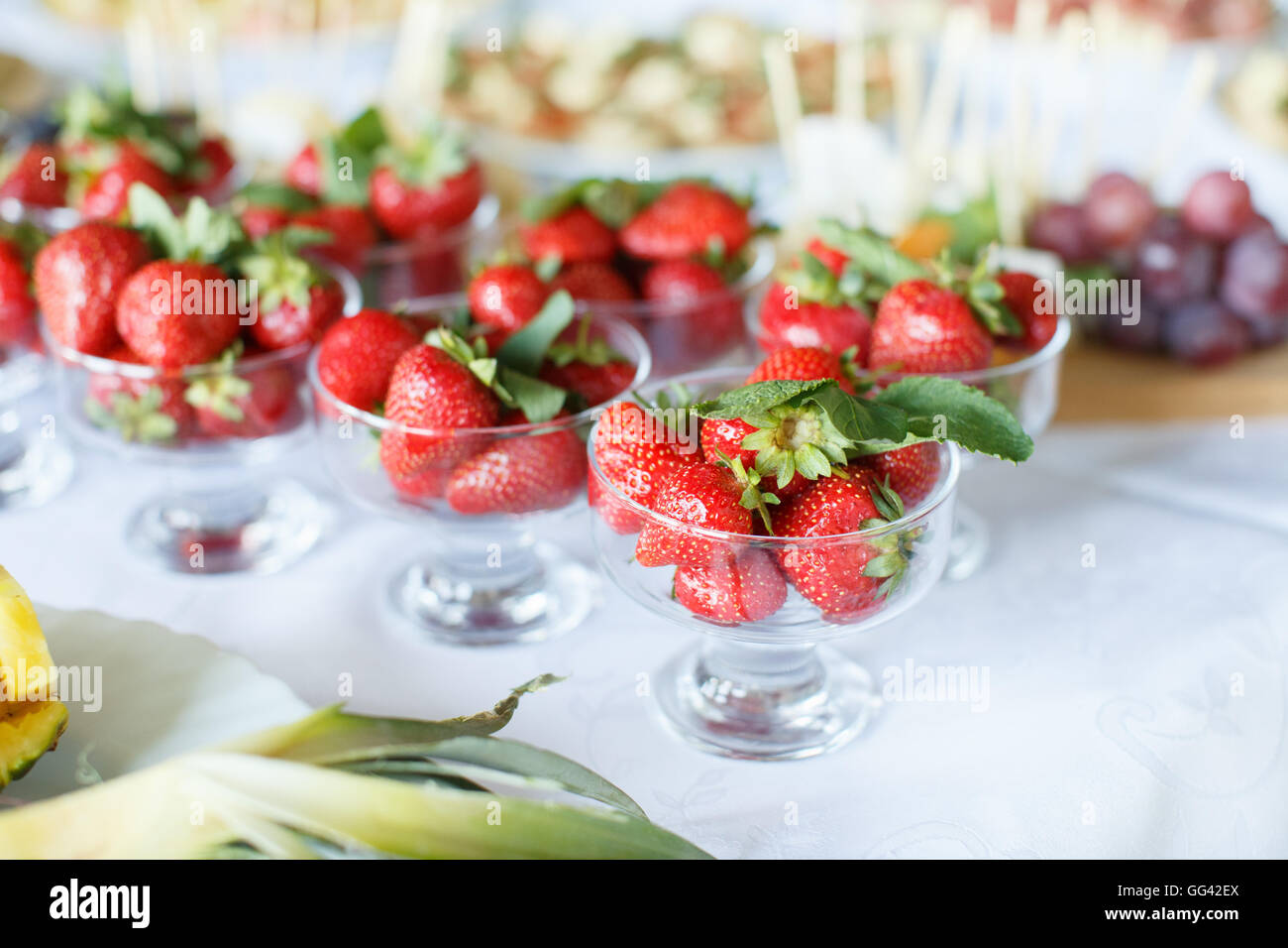 Strawberries in a glass bowl on the white table Stock Photo - Alamy