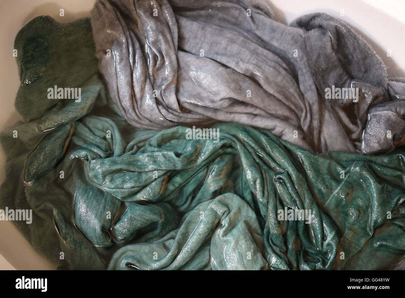 Damp Clothes, Manual Washing in the Sink. Wet garments - shirts in the sink  after hand Laundry. Wet delicate items of clothing after manual laundry  Stock Photo - Alamy