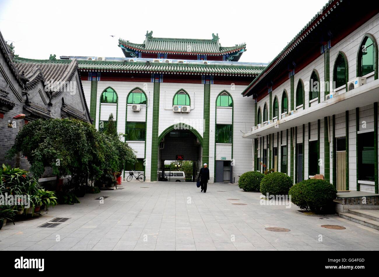 Muslim man walks in entrance courtyard of mosque Beijing China Stock Photo