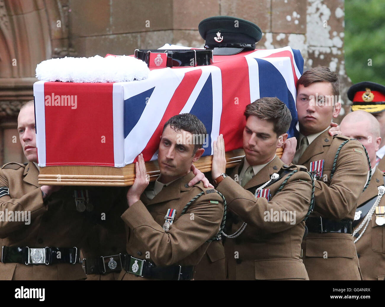 The coffin of Corporal Josh Hoole is carried into Crichton Memorial church in Dumfries for his funeral by colleagues and brother Tyrone (right). Stock Photo