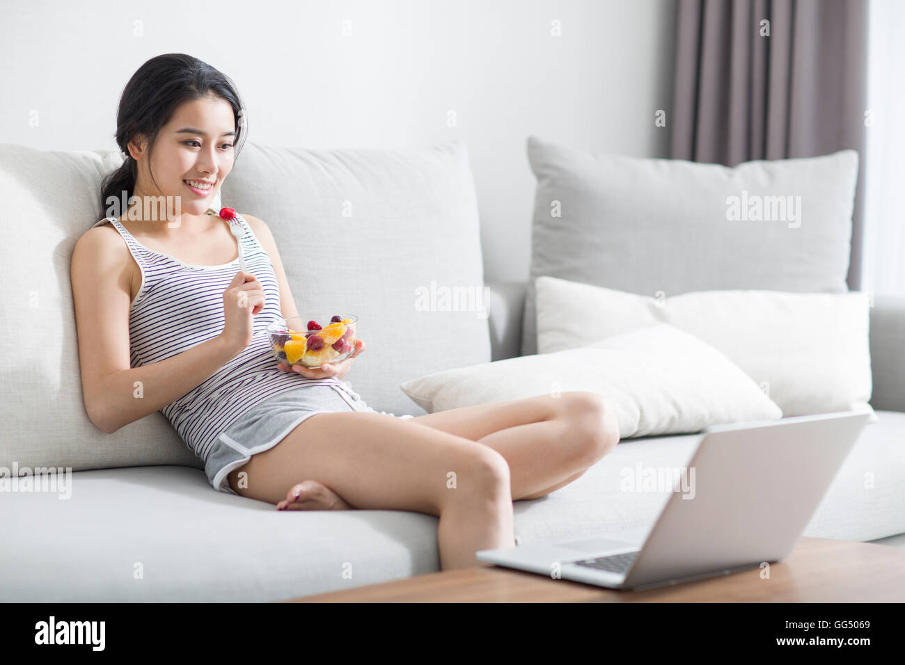Young Chinese woman using laptop at home Stock Photo - Alamy