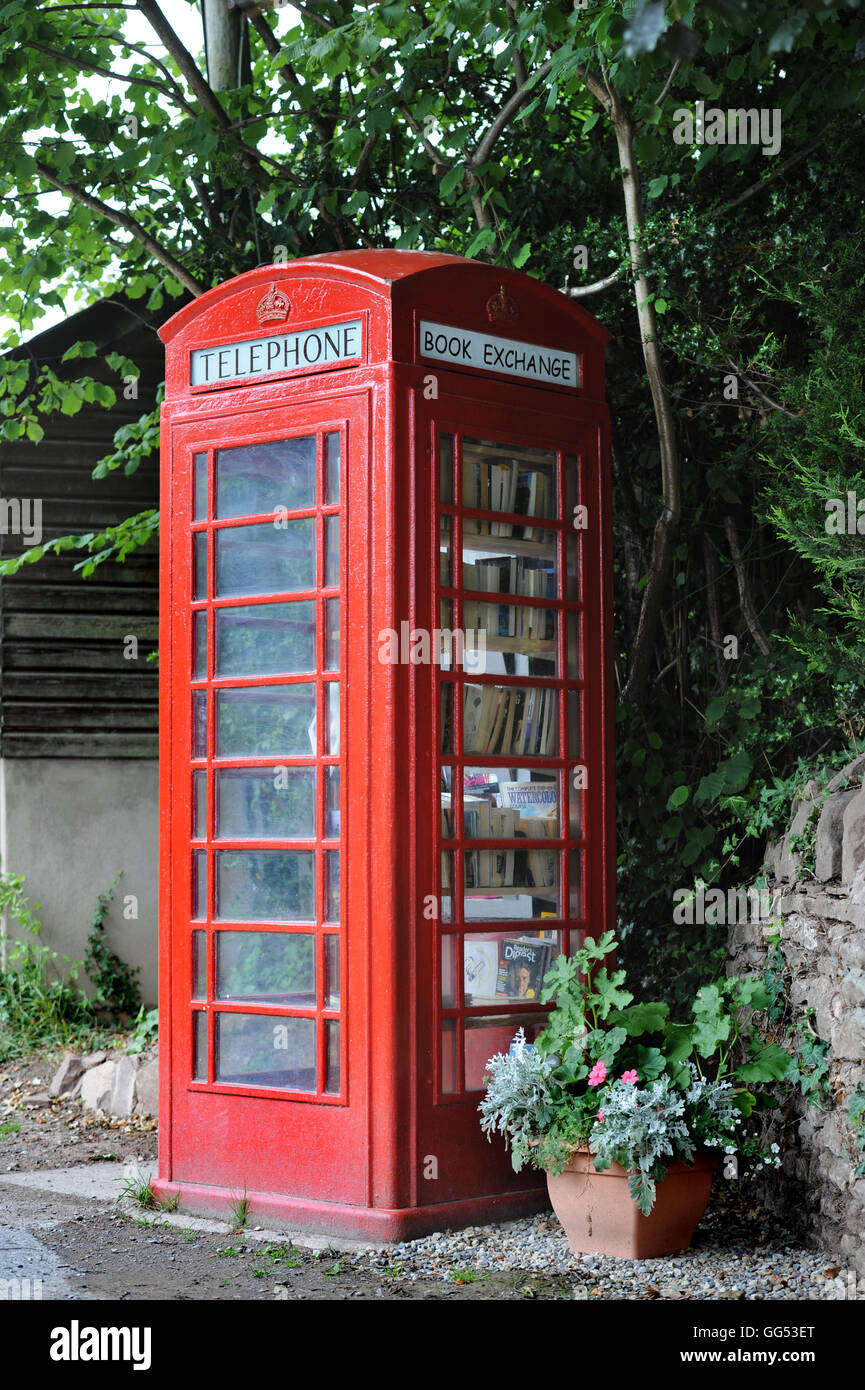 A disused telephone box used as a book exchange in the village of Llangrove in Herefordshire UK Stock Photo