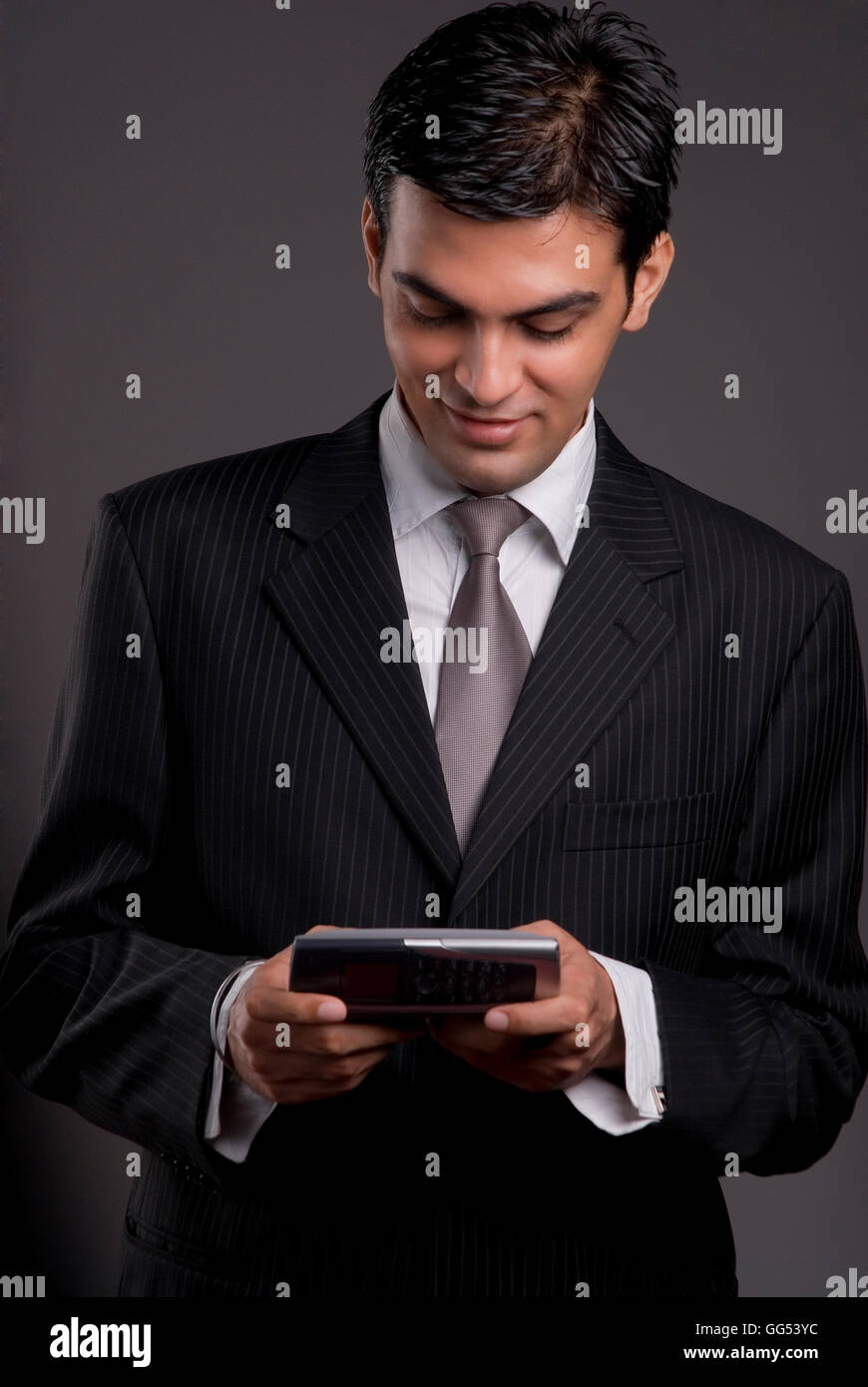 Businessman holding a communicator Stock Photo