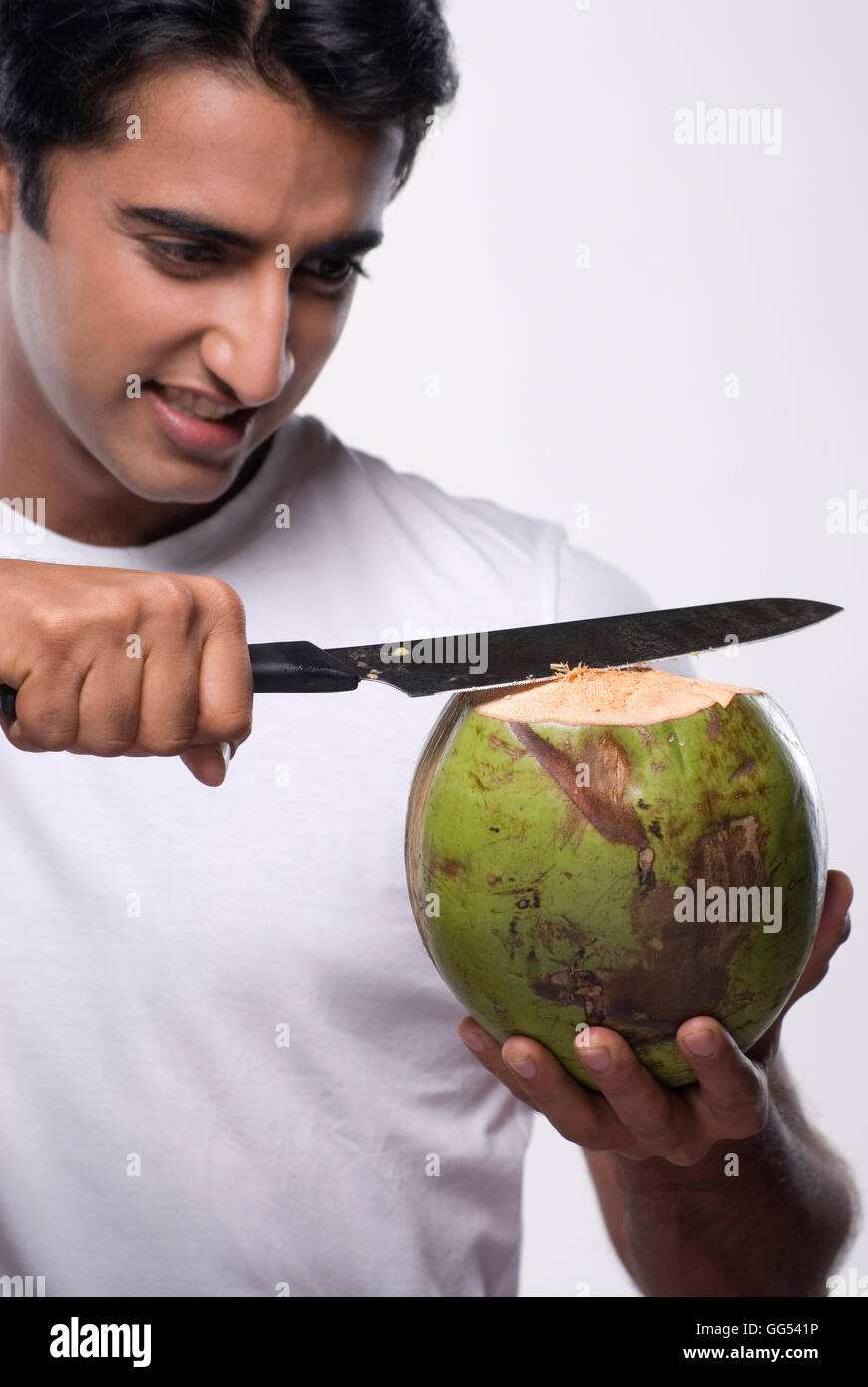 Man cutting a coconut Stock Photo Alamy
