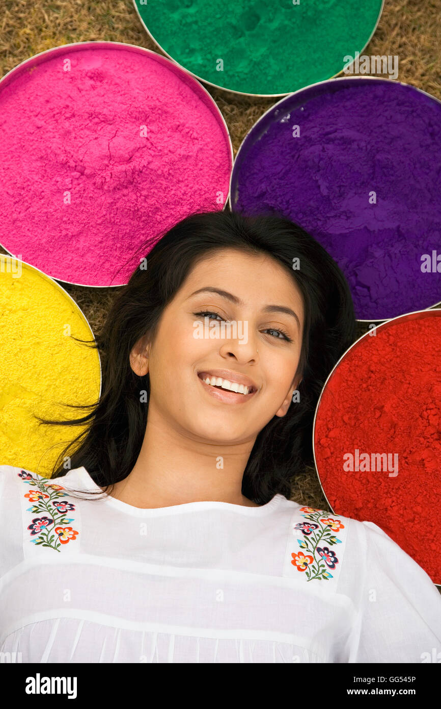 Woman lying with trays of gulal Stock Photo