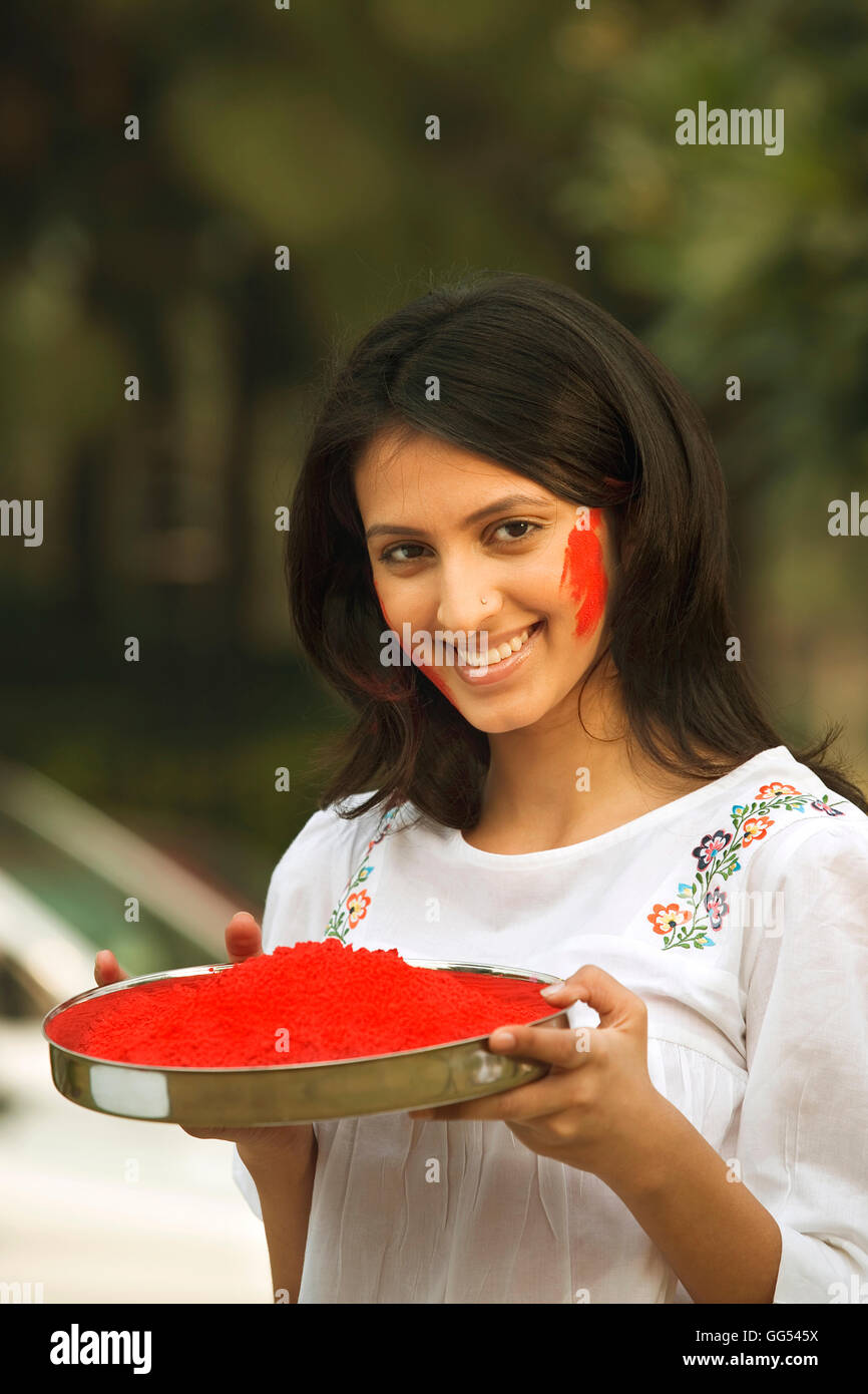 Woman holding a plate of gulal Stock Photo