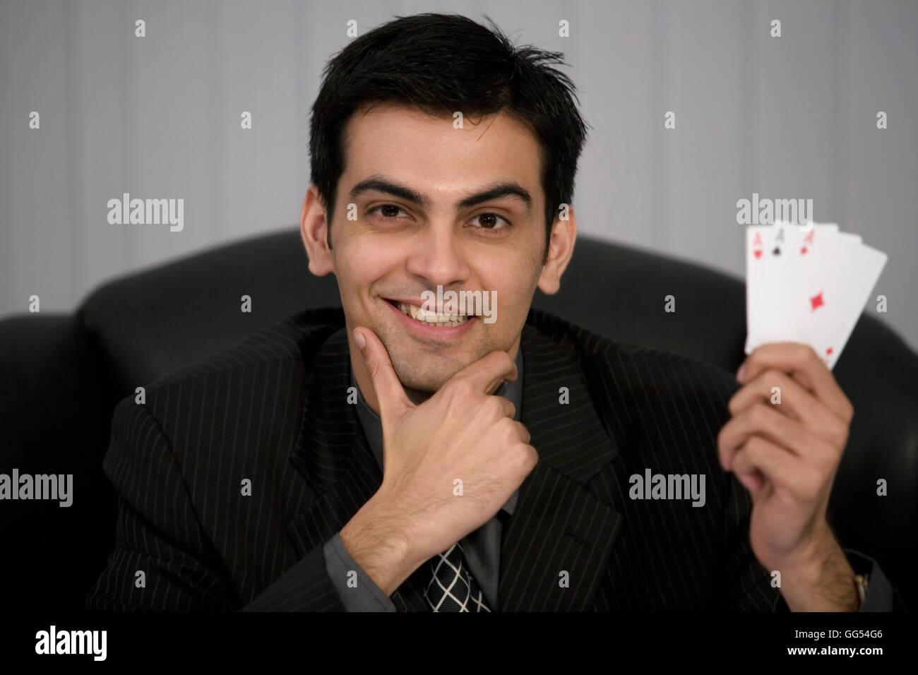 Man holding three aces Stock Photo