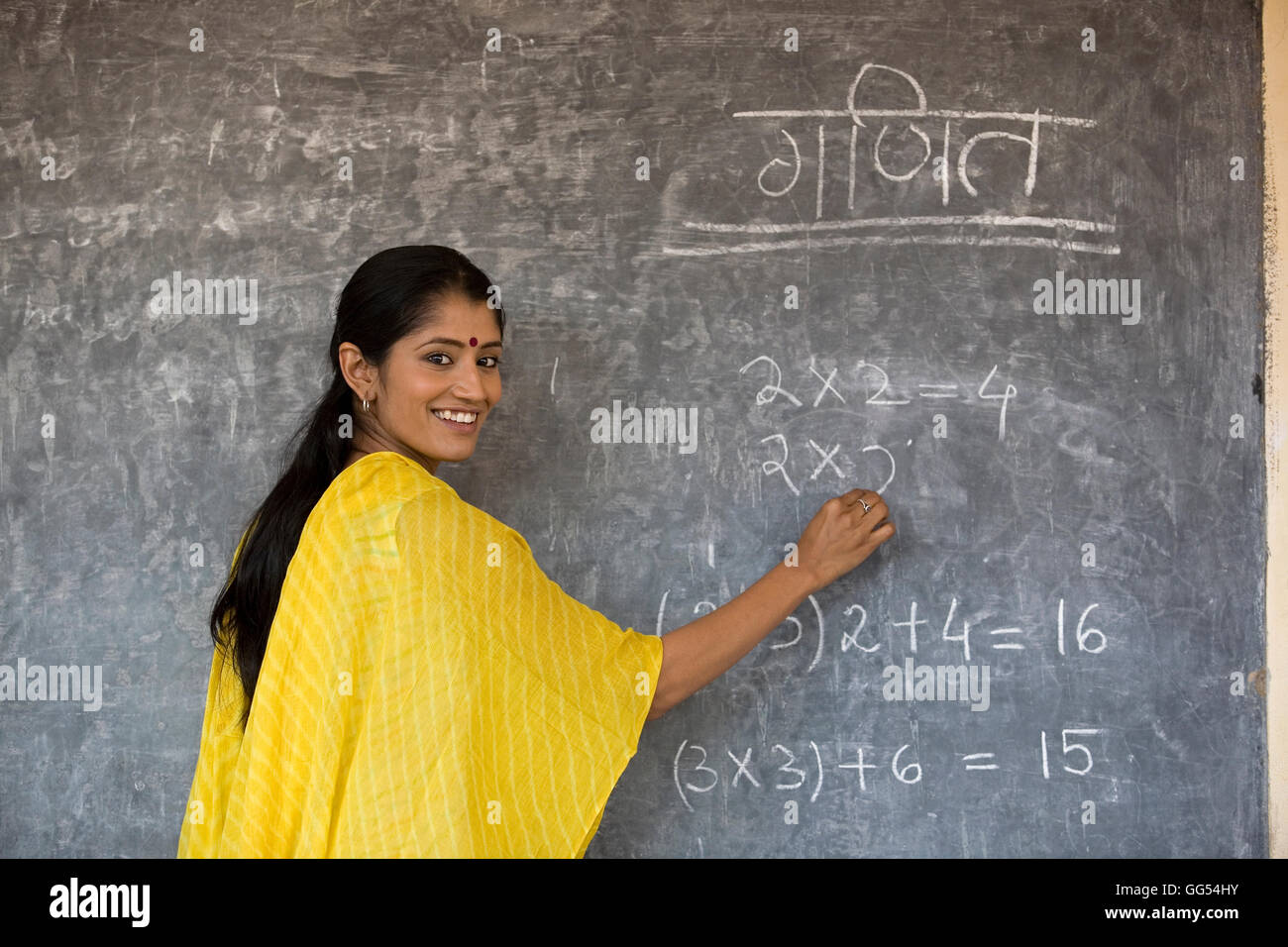 Rural teacher writing on the board Stock Photo Alamy