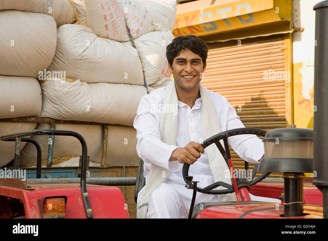 A farmer on his tractor Stock Photo - Alamy