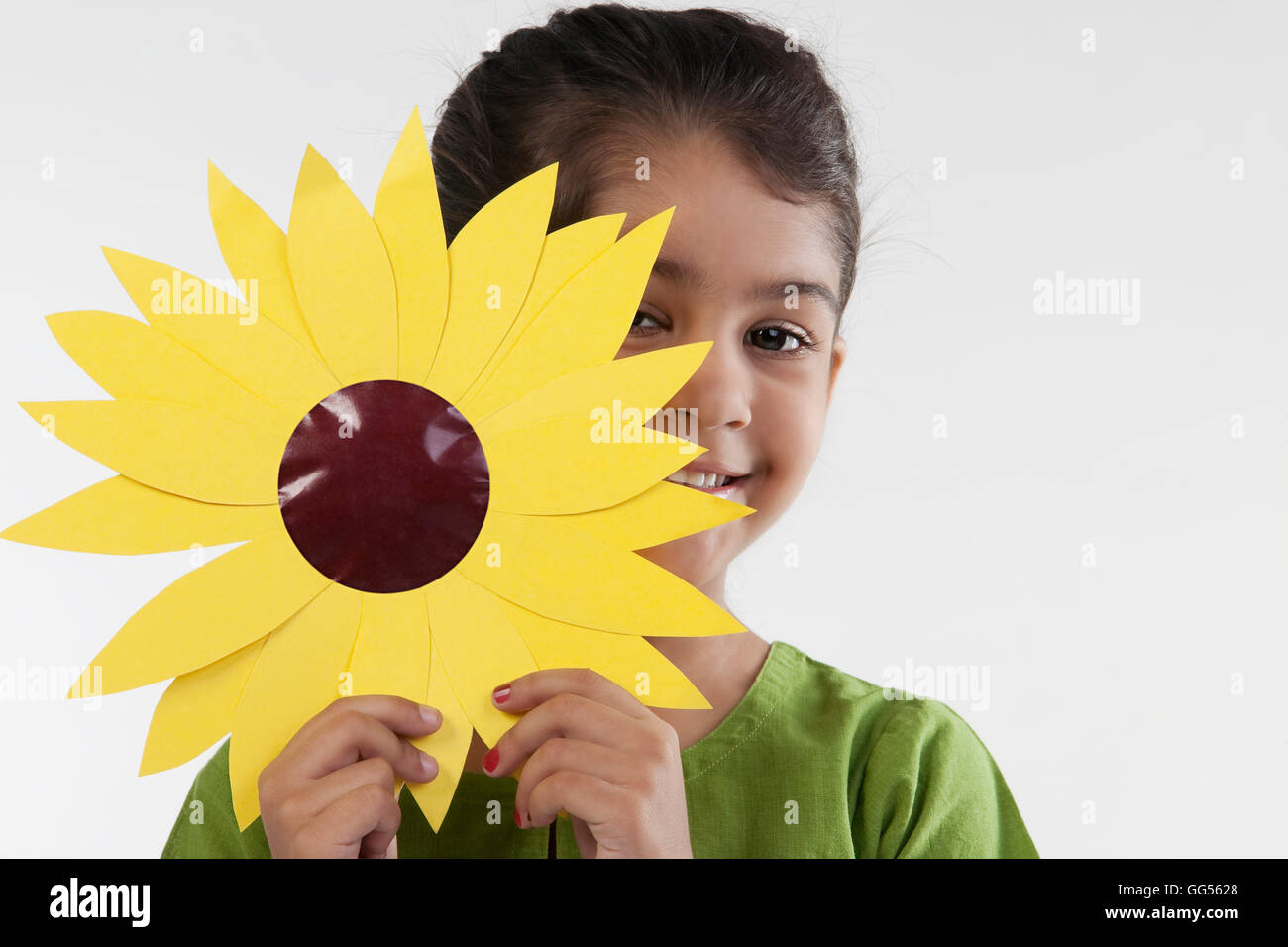Girl holding a paper flower Stock Photo