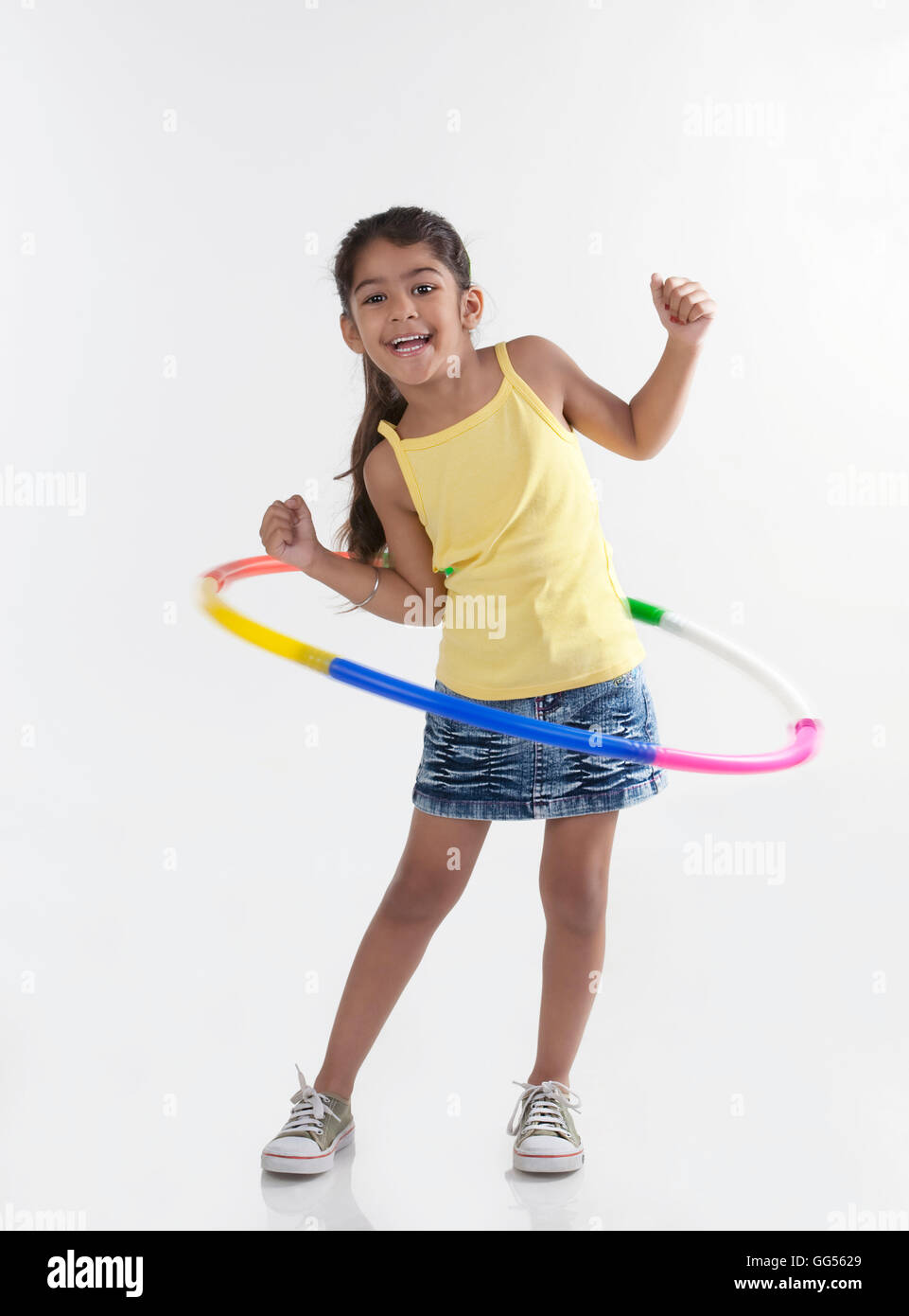 Girl playing with a hoola hoop Stock Photo