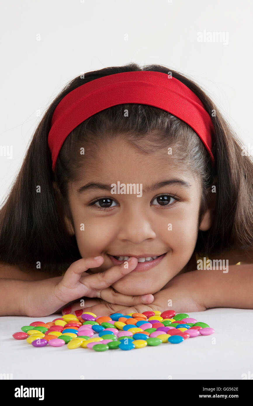 Girl with different coloured sweets Stock Photo