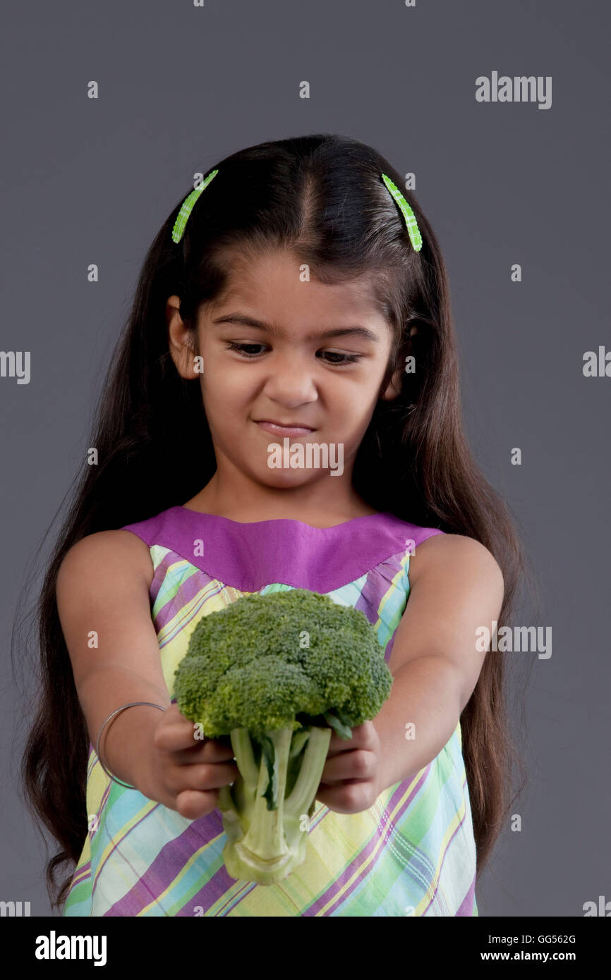 Girl holding broccoli Stock Photo Alamy