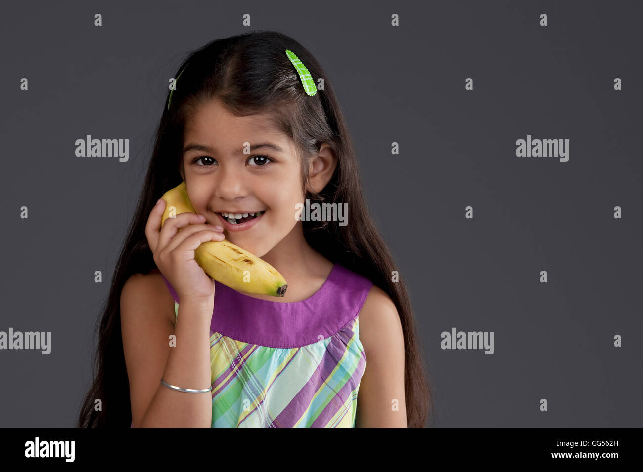Girl using a banana as a phone Stock Photo