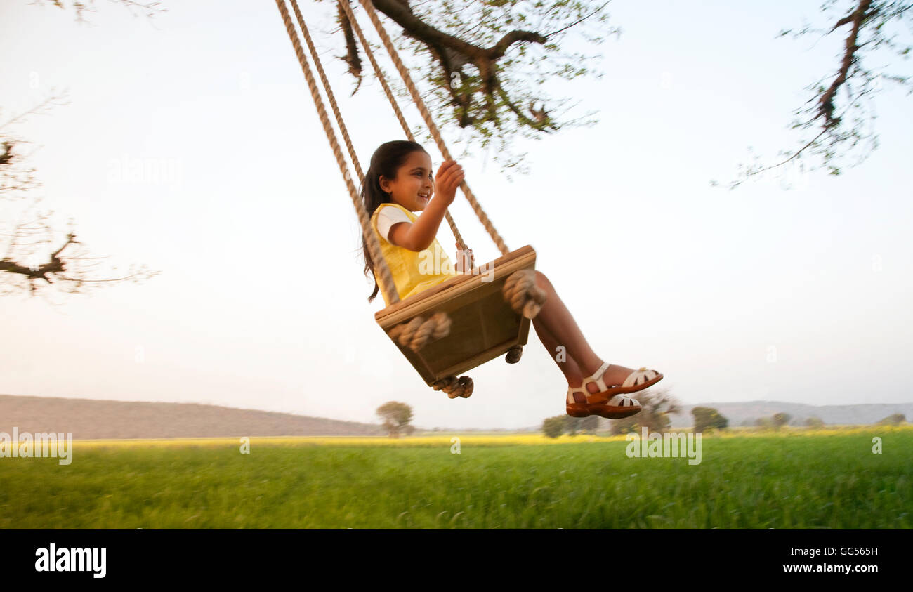 Young girl on a swing Stock Photo