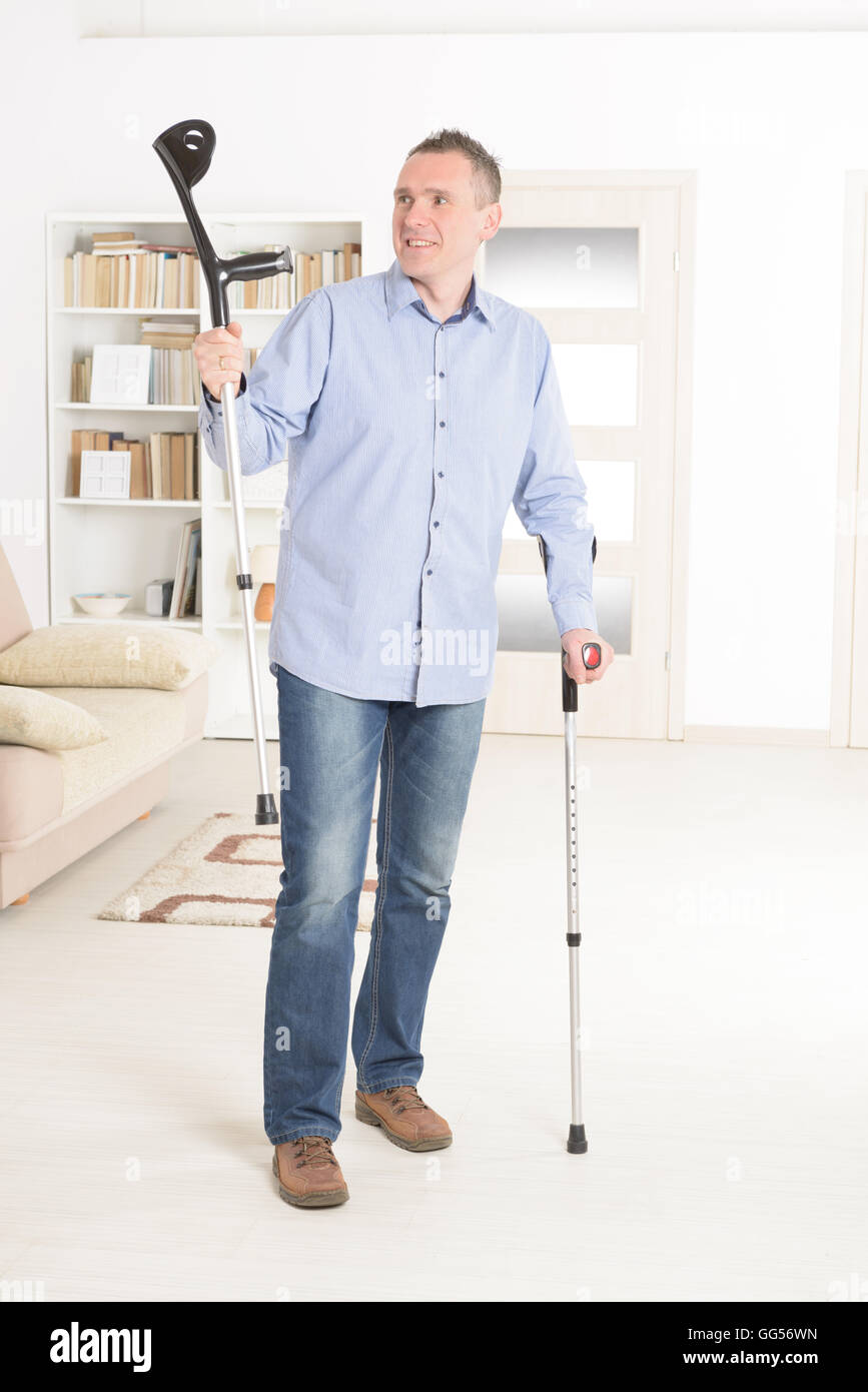 Man with crutches, rehabilitation after injury Stock Photo Alamy