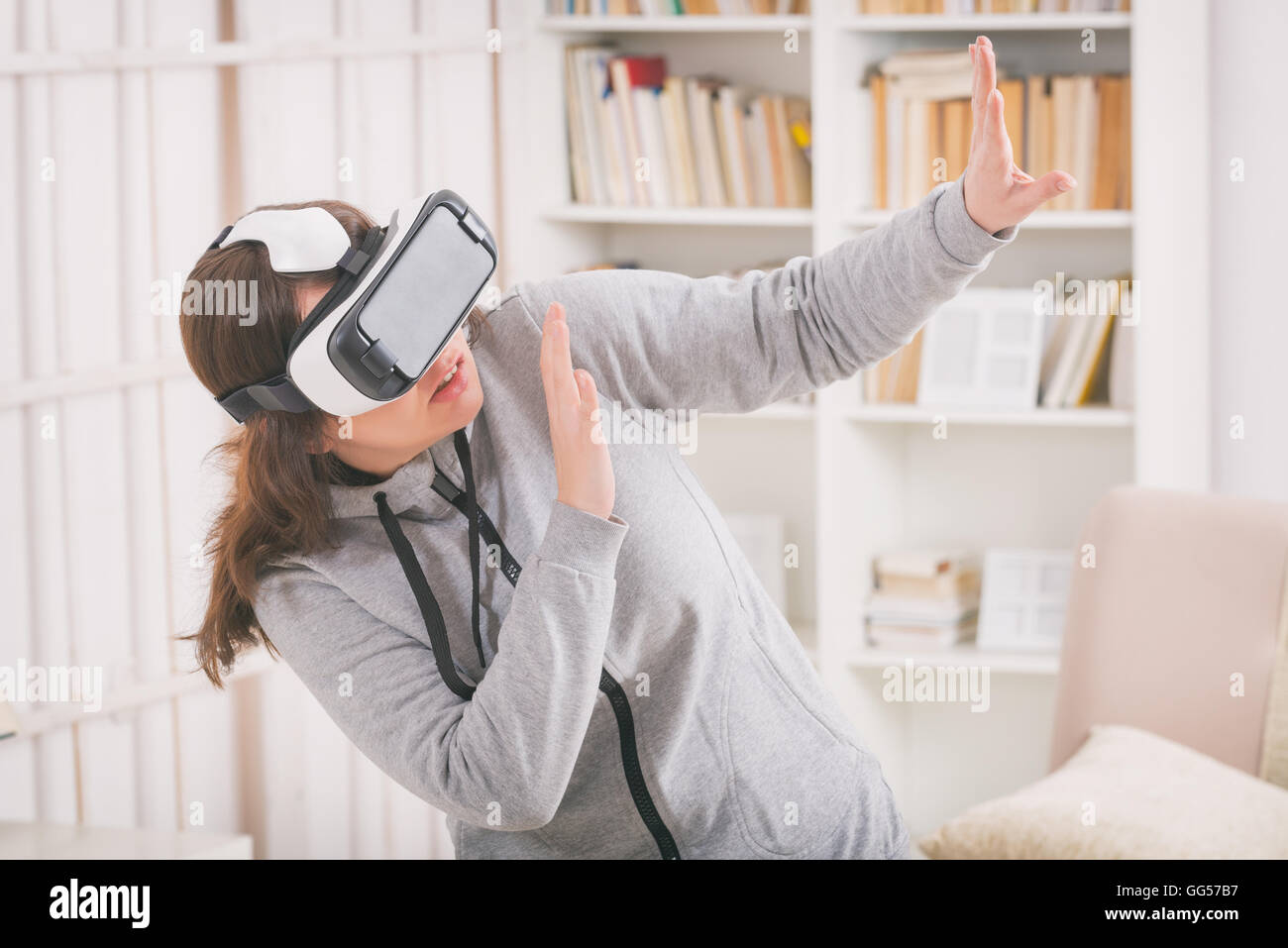 Woman using virtual reality headset to fight her phobias or fears at home Stock Photo Alamy