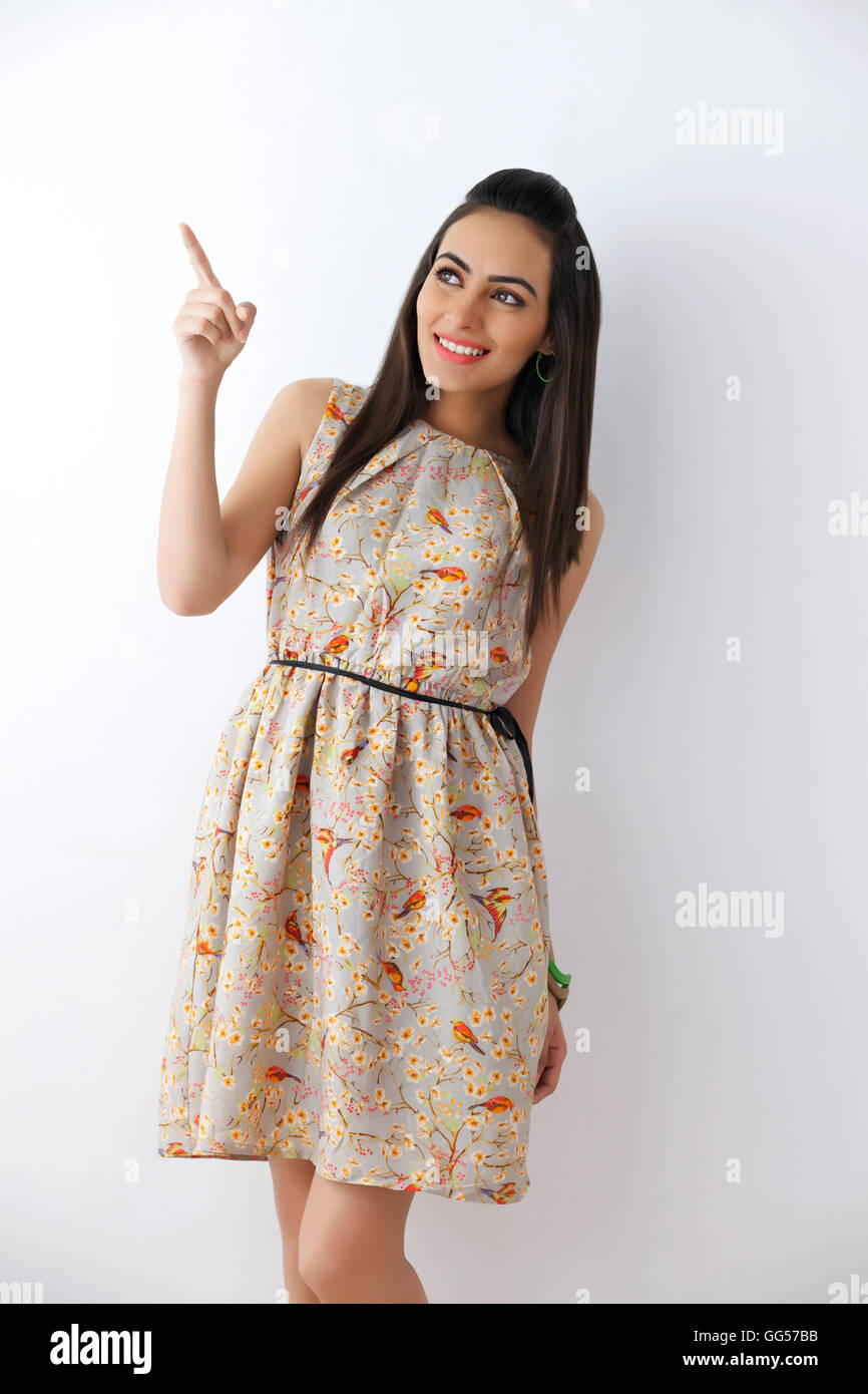 Beautiful young Indian woman pointing on white background Stock Photo ...