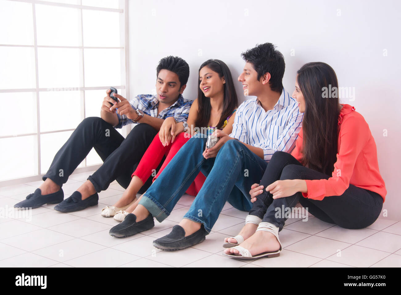 Full length of college friends spending leisure time in college Stock Photo