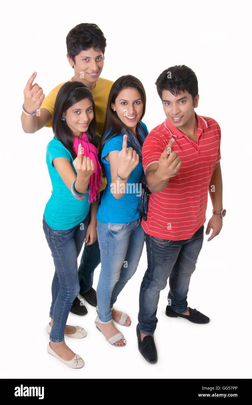 High angle portrait of friends showing index finger after casting vote against white background Stock Photo