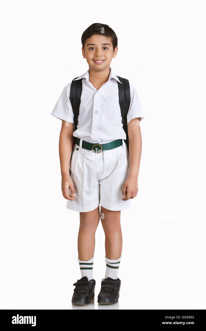 Full length portrait of boy wearing school uniform over white background Stock Photo