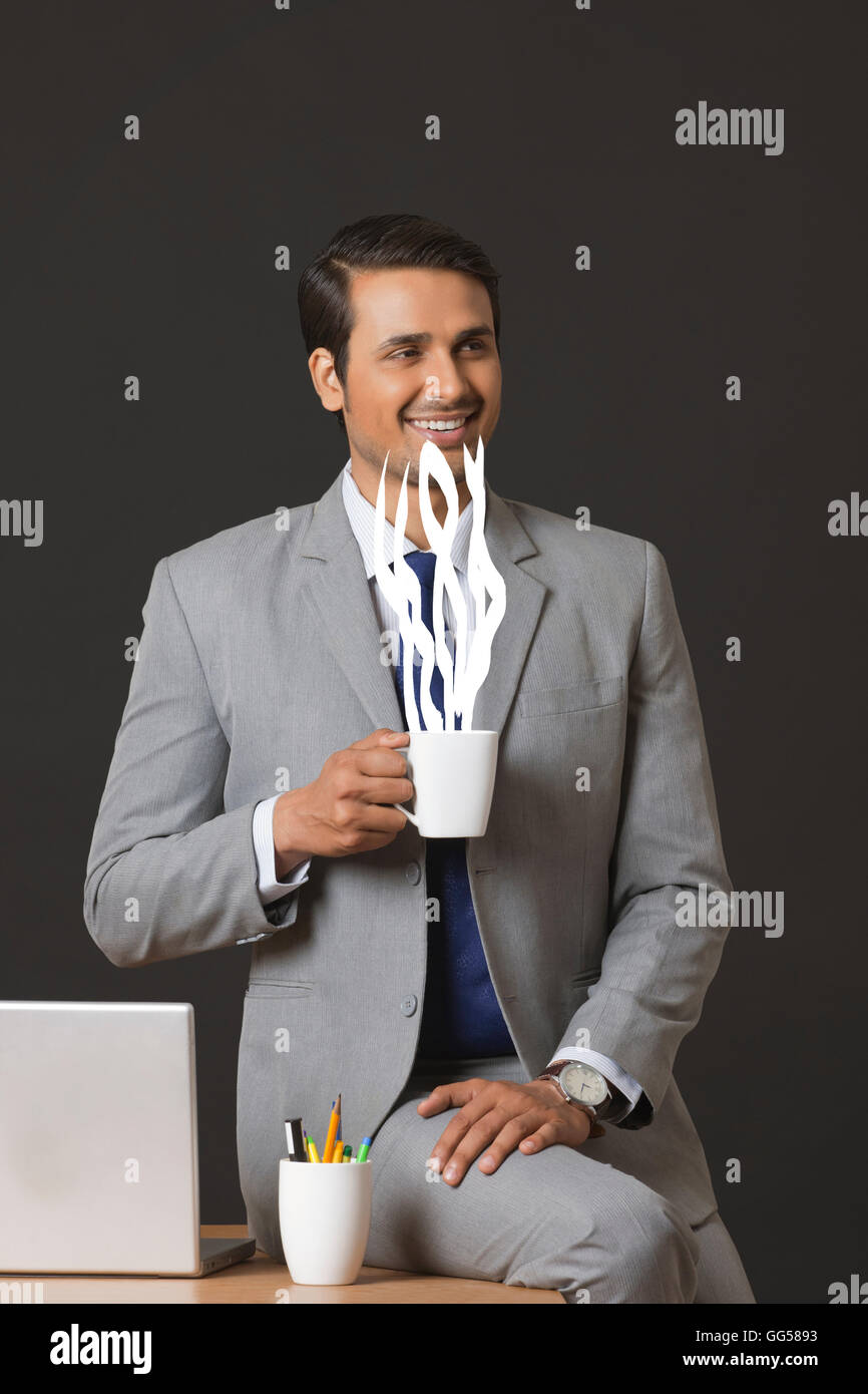 Digitally generated image of businessman having coffee in office Stock Photo
