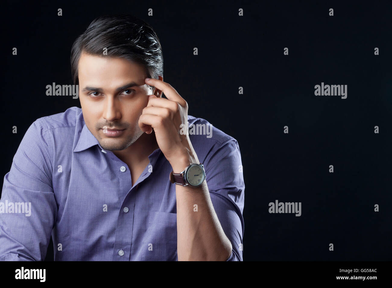 Portrait of confident businessman over black background Stock Photo