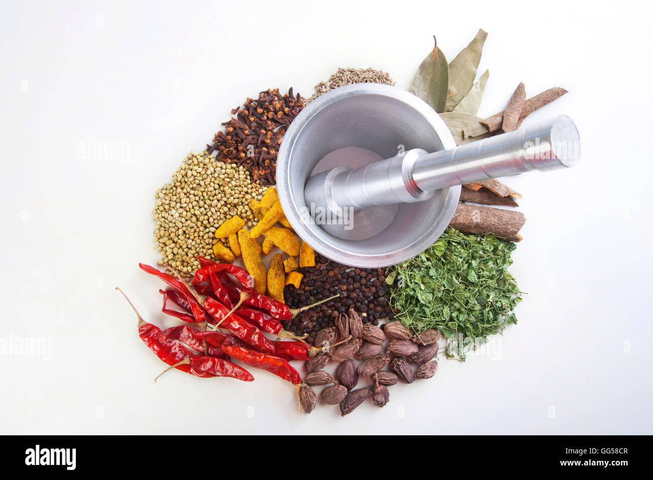 Various kind of spices with mortar and pestle on white background Stock Photo