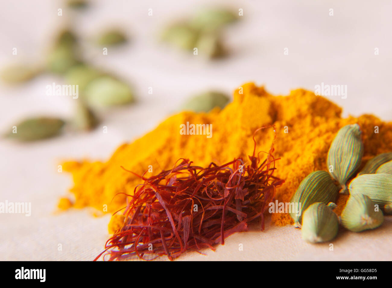 Green cardamom pods, saffron and turmeric powder Stock Photo