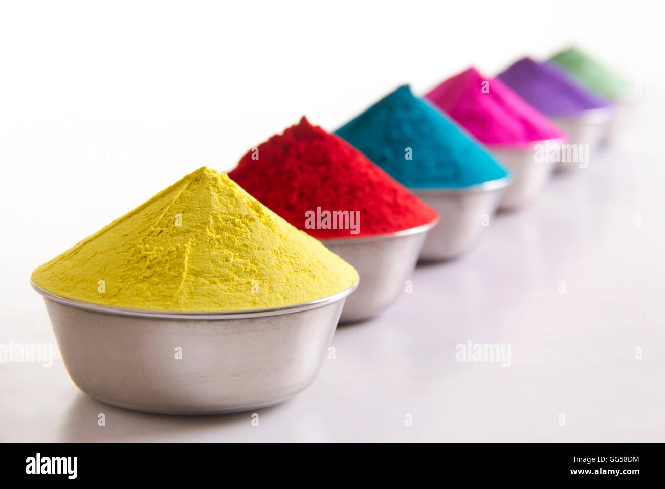 Colorful Holi powder in containers over white background Stock Photo - Alamy