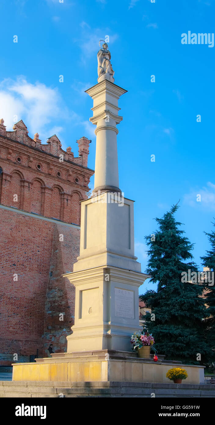 A statue of the Virgin on a high pedestal in front of the town hall in Sandomierz. Poland Stock Photo