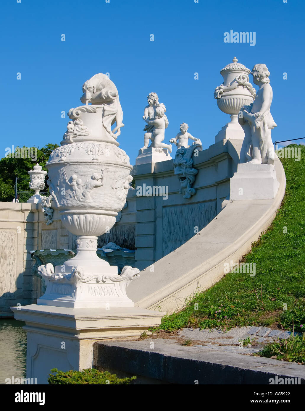 Statues and vases of children with mythical animals on the parapet of the fountain in the Belvedere. Austria. Stock Photo