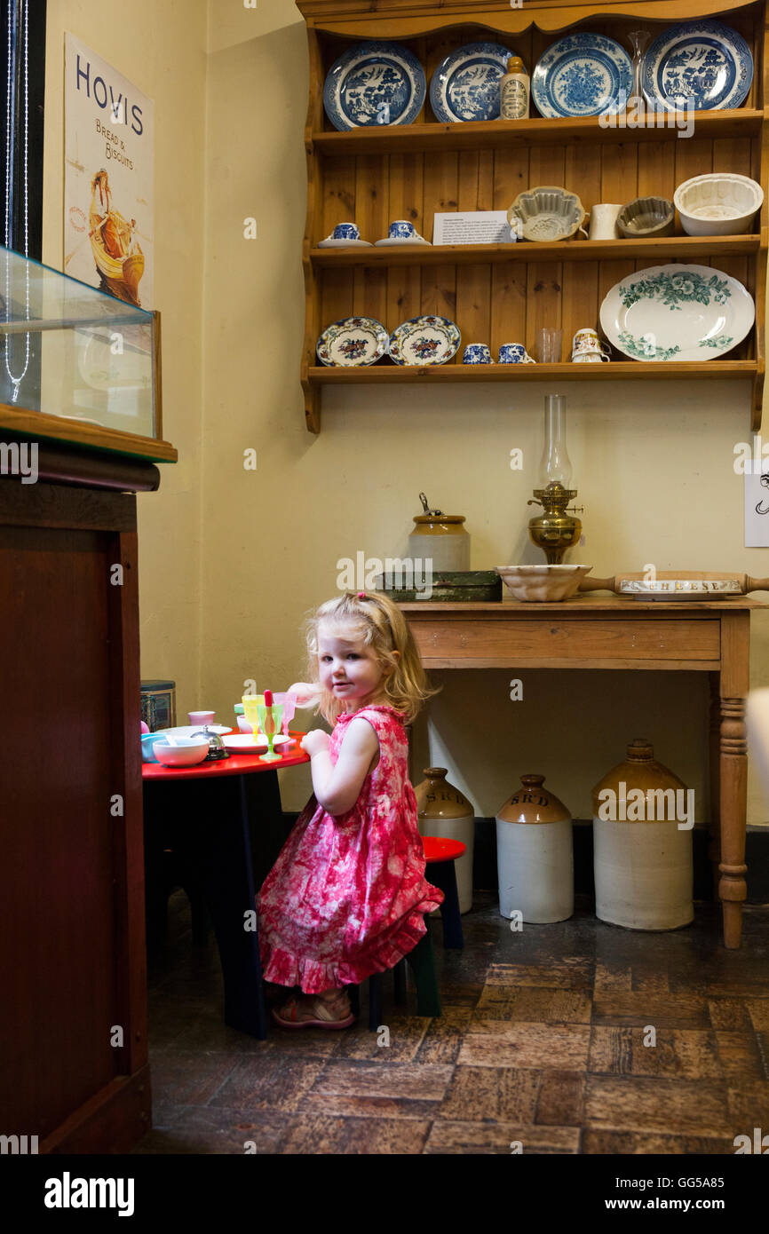 Child plays in the period style kitchen at the The Tudor House Museum. Friar St / Friar street, Worcester WR1 2NA. UK Stock Photo