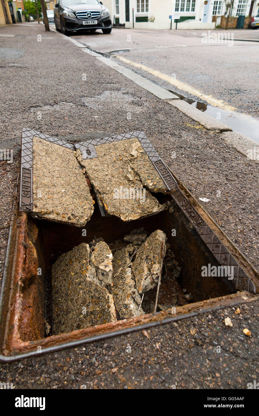 Dangerous hole in the pavement / sidewalk where a manhole cover has