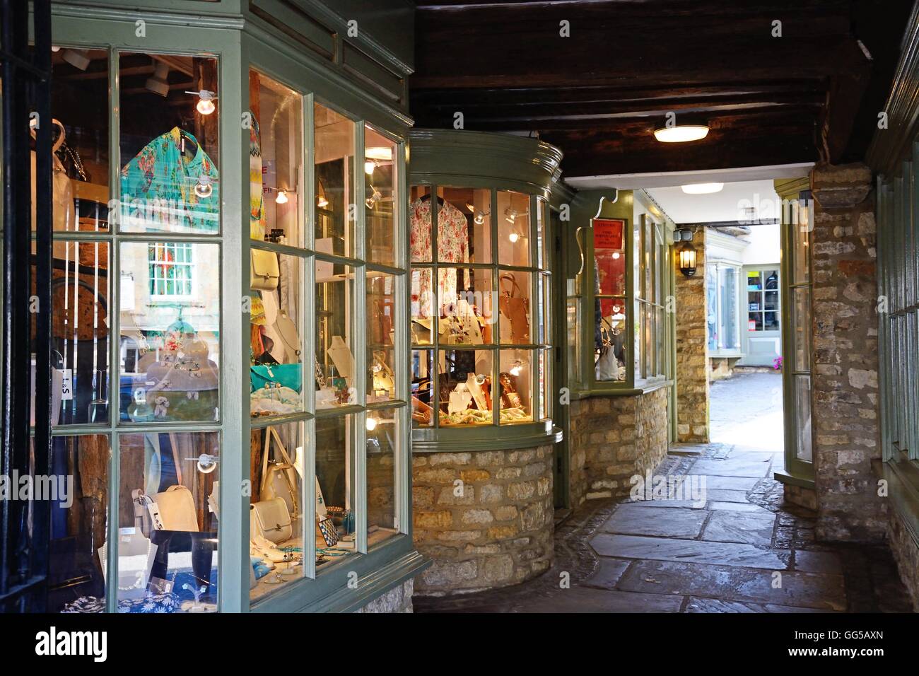 Small shops in a traditional old shopping arcade along The Hill shopping street, Burford, Oxfordshire, England, UK, Europe. Stock Photo