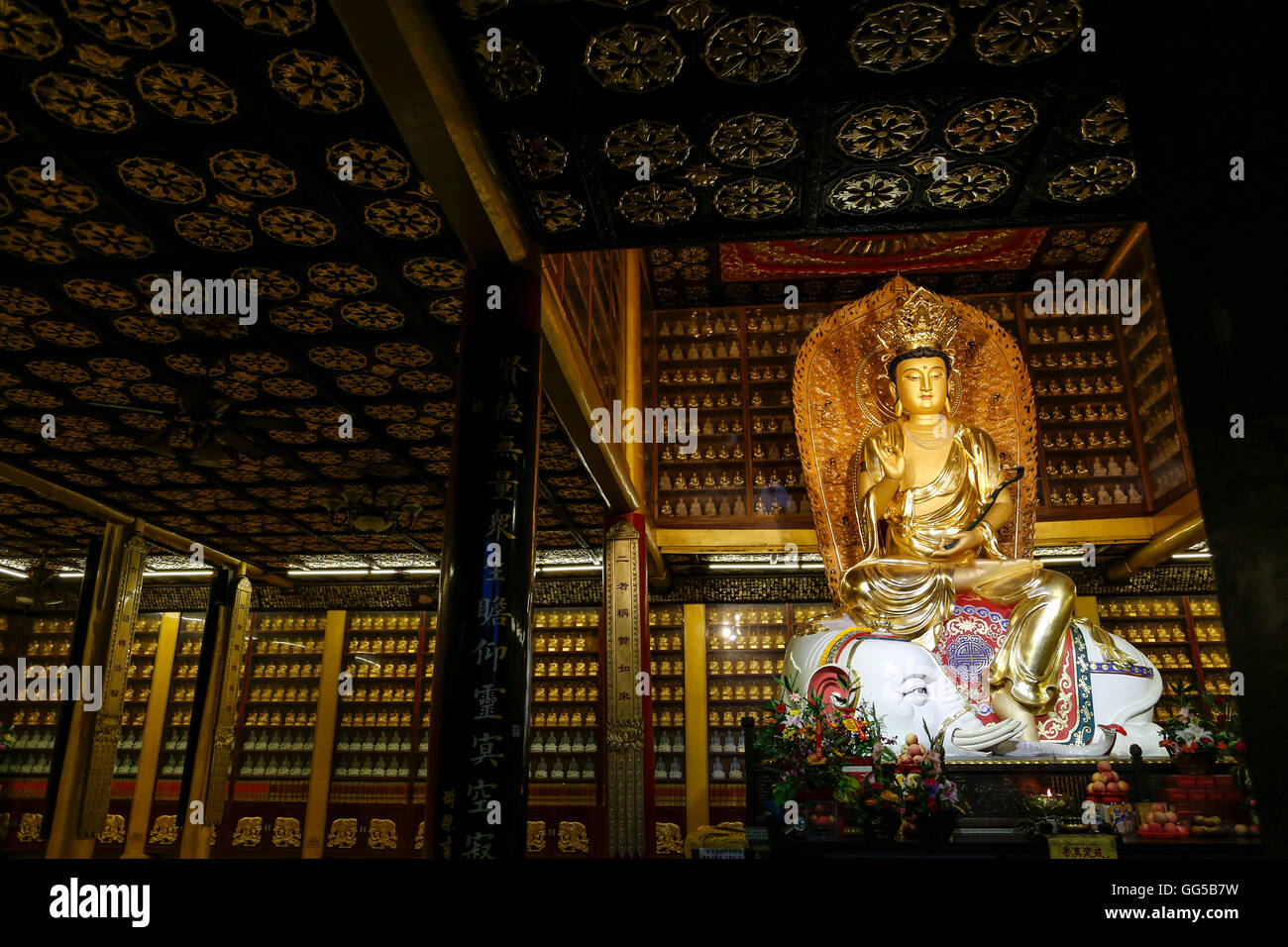 Buddha statue and ornate decorations in one of the halls at Baoguo Temple, Mt. Emei, Leshan, Sichuan, China. Stock Photo