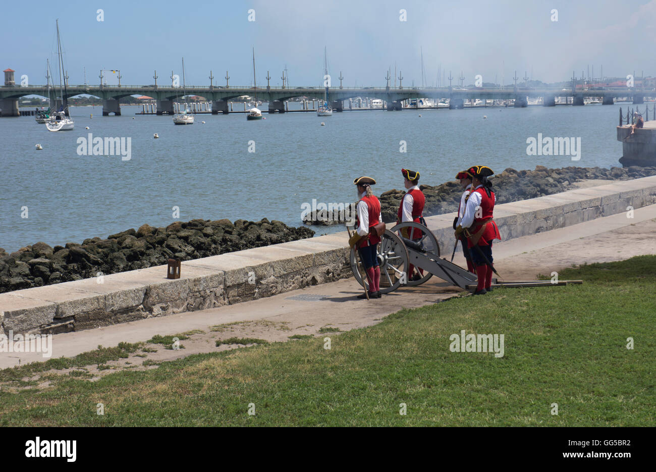 Reenactment of Early American soldiers firing a canon from base of the fort in St. Augustine, Florida. Stock Photo