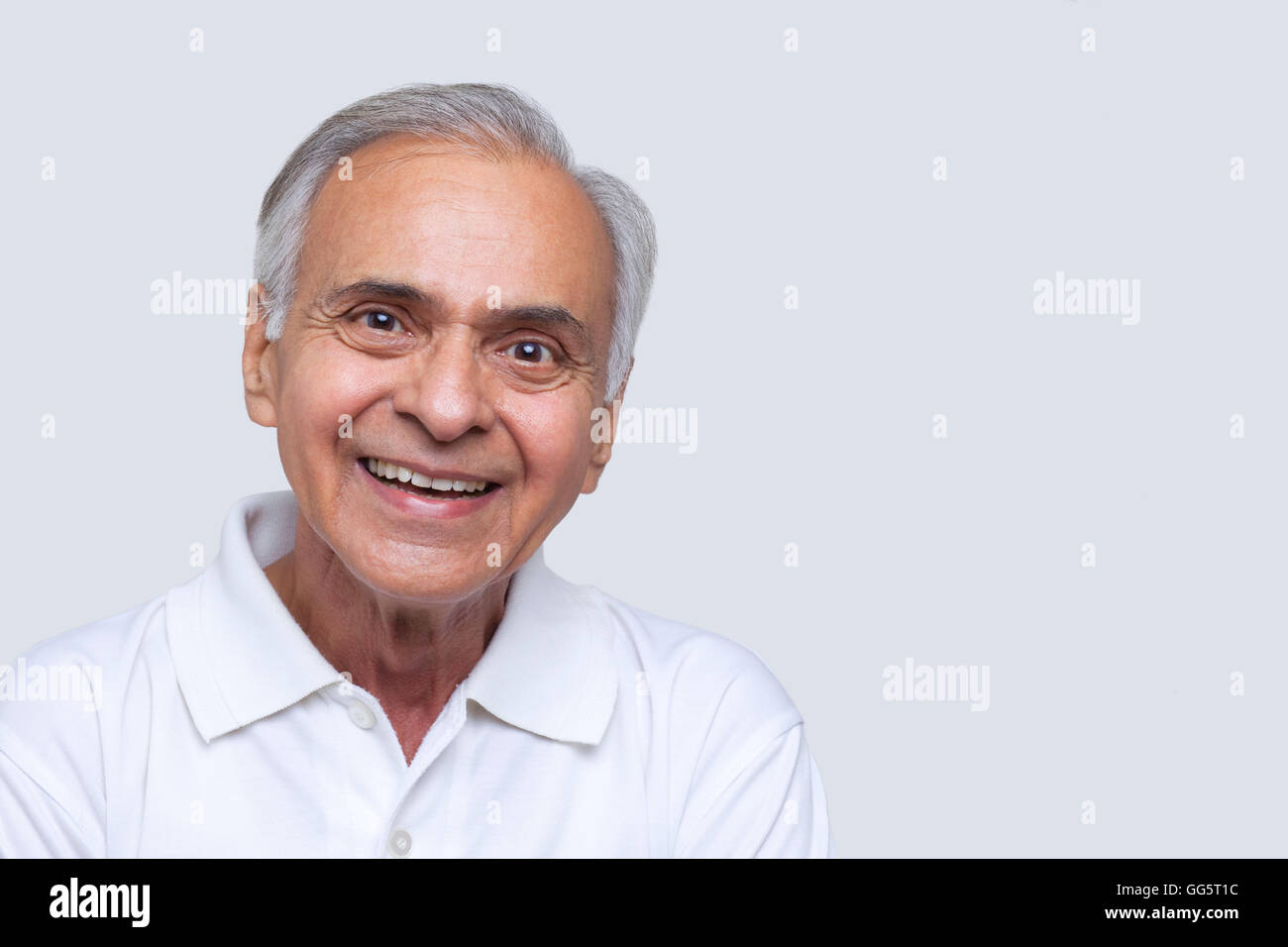 Portrait of smiling senior man over white background Stock Photo - Alamy