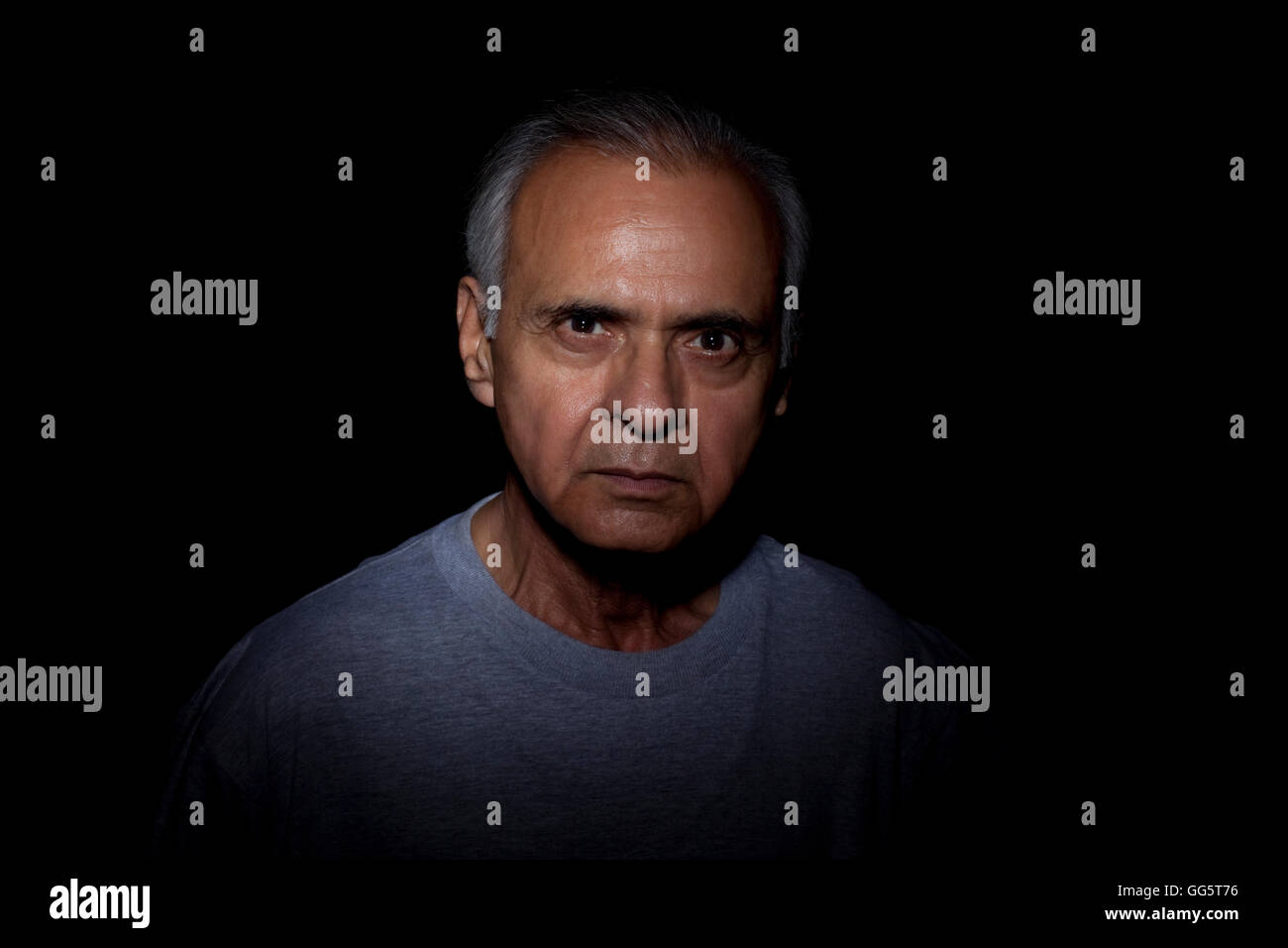 Portrait of serious man over black background Stock Photo