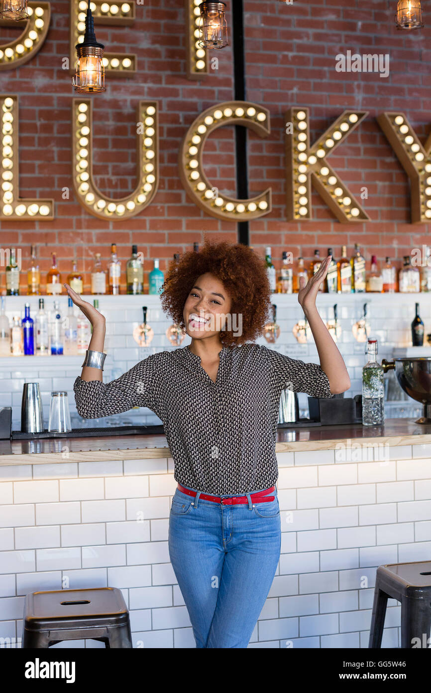 Portrait of happy young woman having fun at bar counter Stock Photo