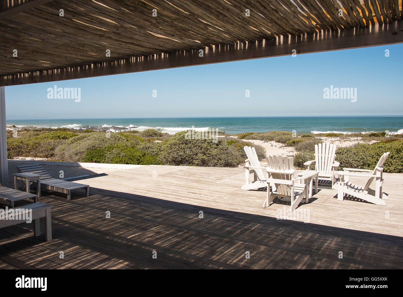 Adirondack chairs on porch in resort at seaside Stock Photo Alamy