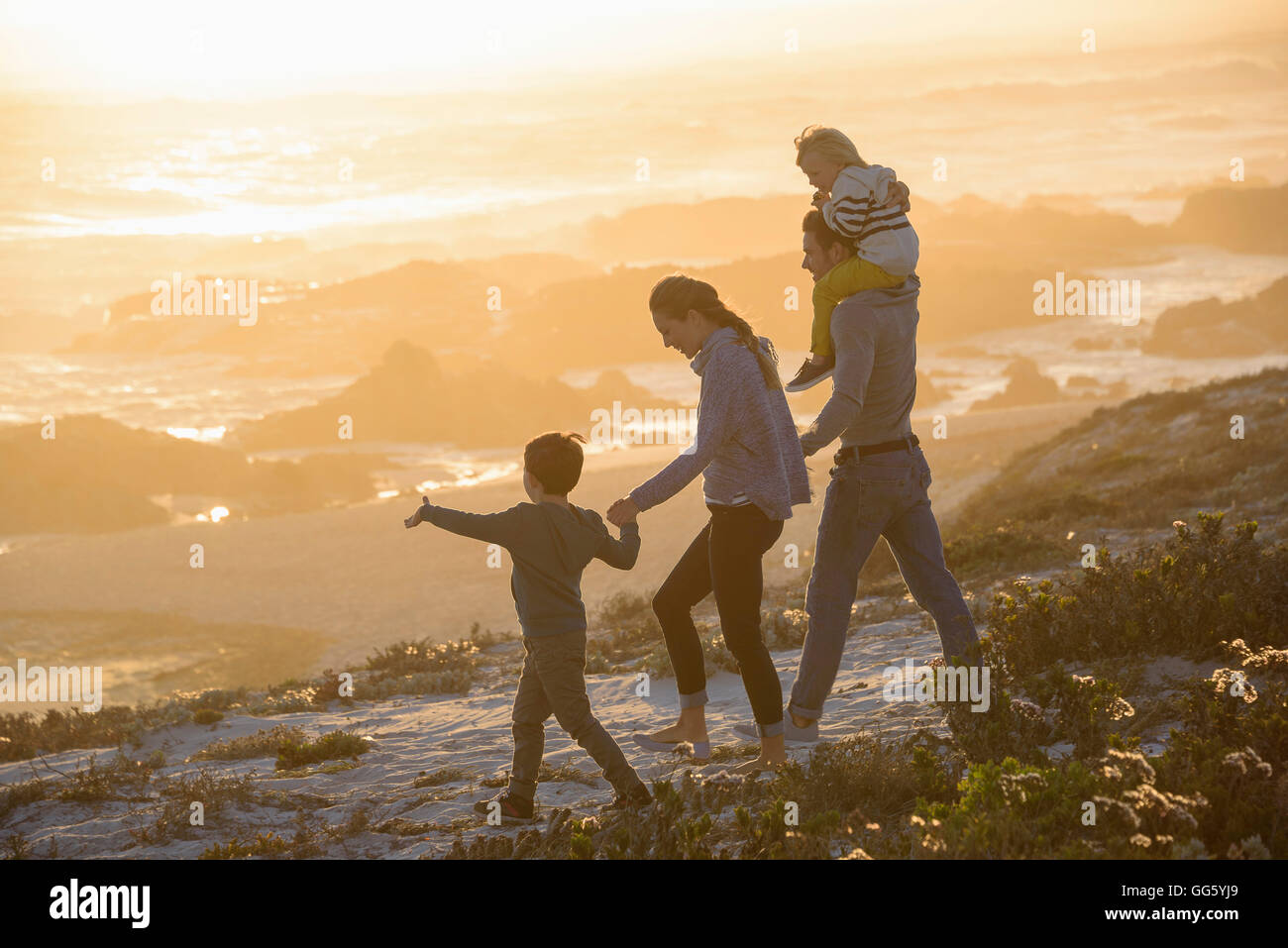 Family on beach at dusk hi-res stock photography and images - Alamy