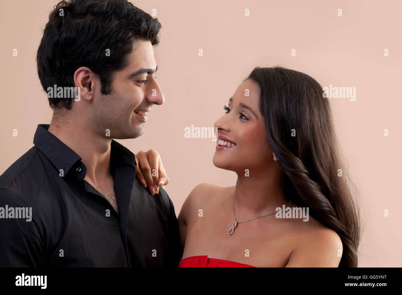 Cute Indian couple looking at each other with love Stock Photo - Alamy
