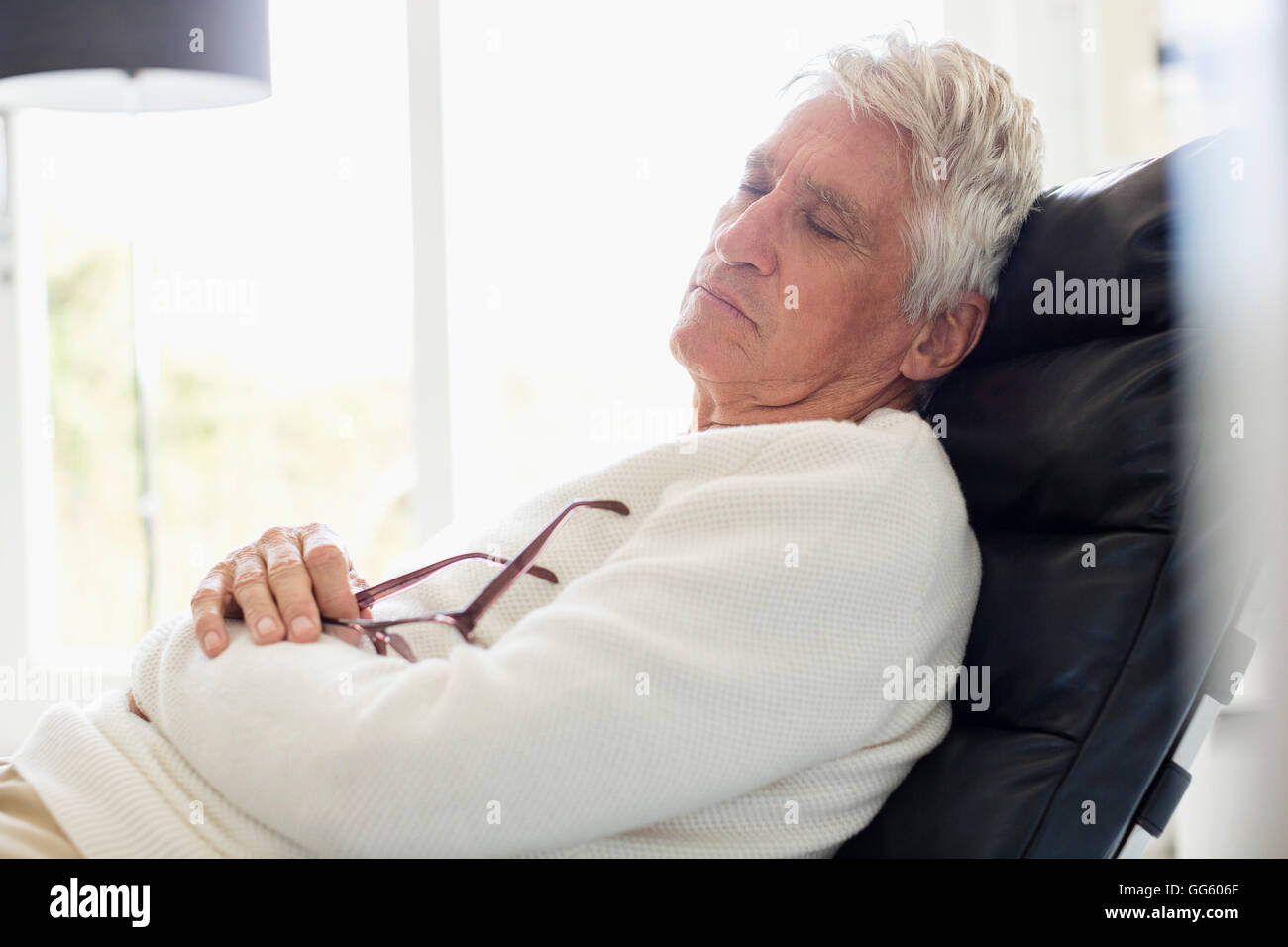 Senior man sleeping on chair Stock Photo Alamy