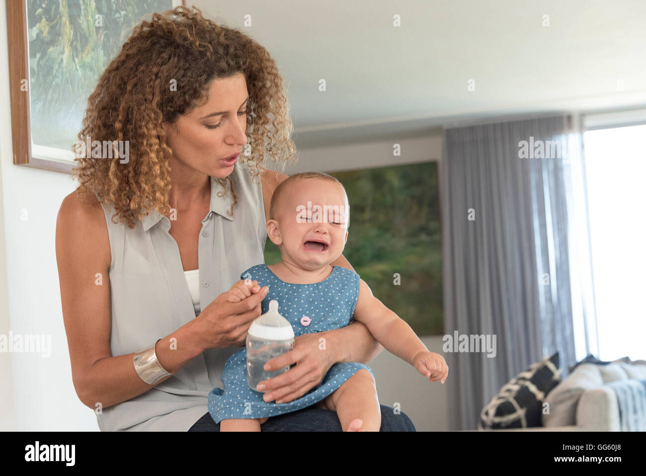 Close-up of a mother consoling her crying baby Stock Photo