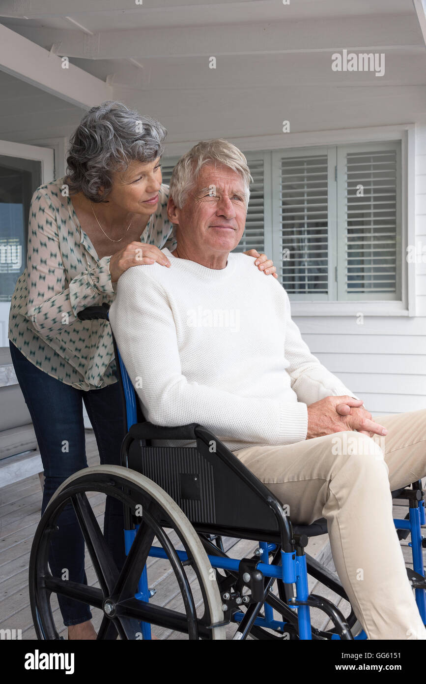 Senior man in wheelchair with his wife on porch Stock Photo Alamy