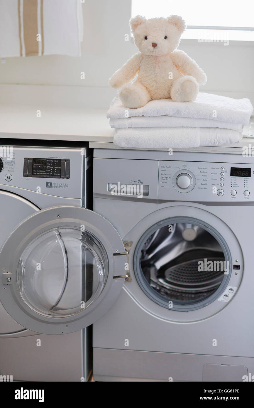 Teddy bear on washing machine at home Stock Photo Alamy