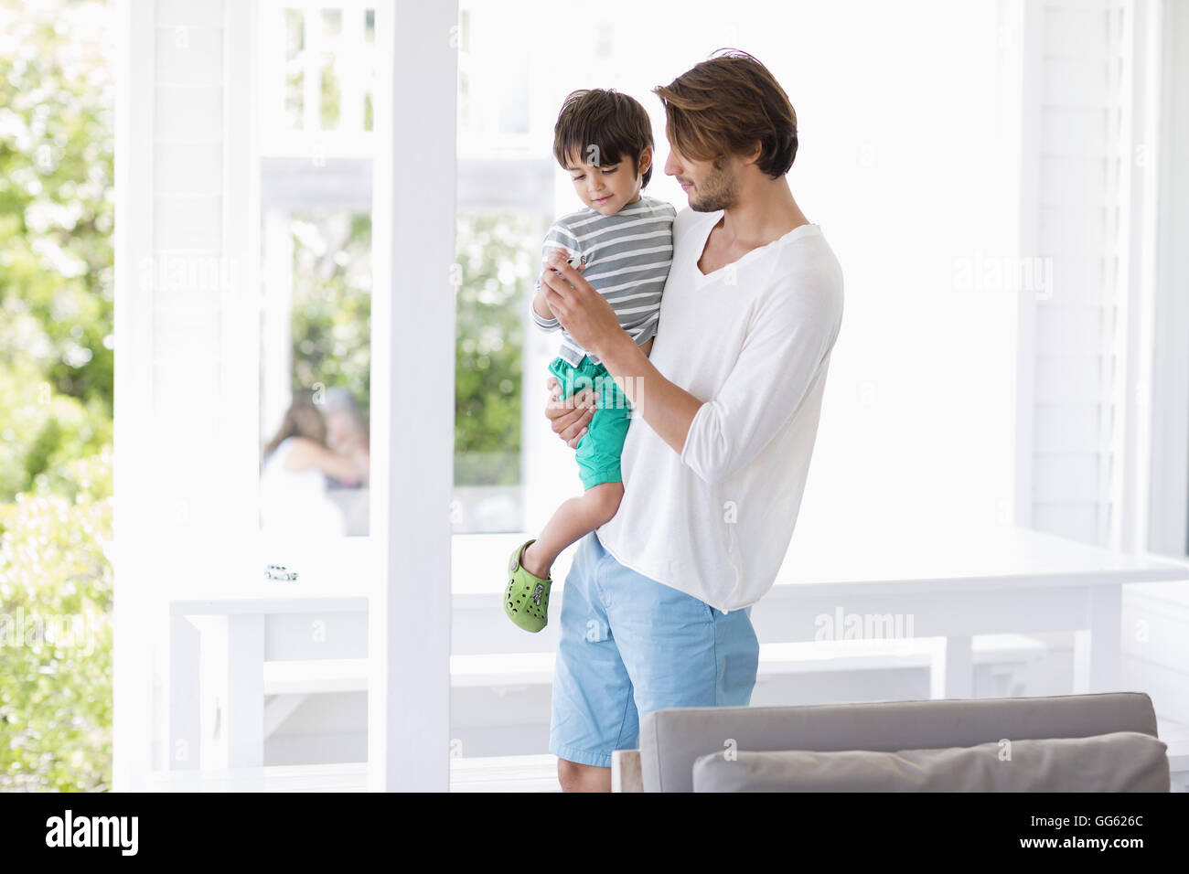 Father and son in living room at home Stock Photo - Alamy
