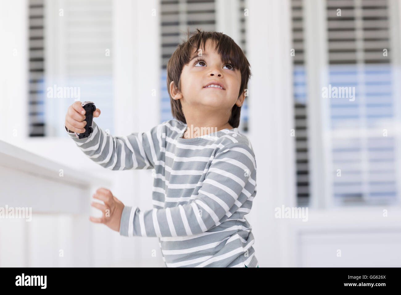 Happy boy playing with a toy car Stock Photo - Alamy